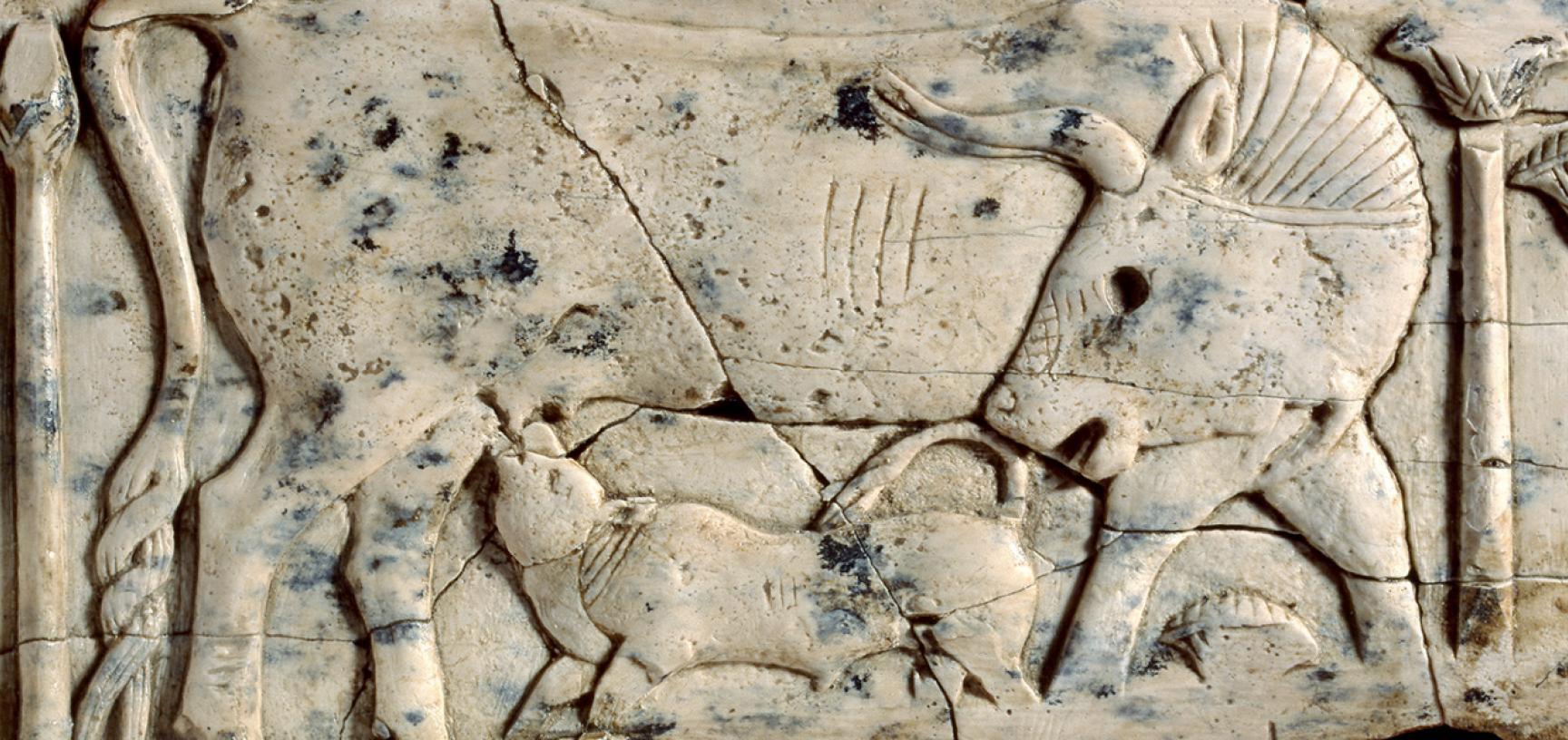 Ivory plaque of a cow and calf among papyrus plants