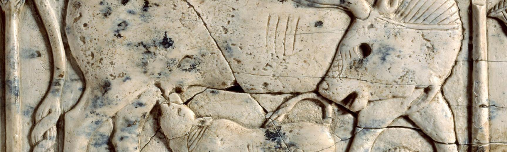Ivory plaque of a cow and calf among papyrus plants