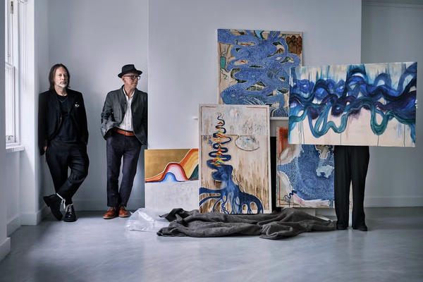 Radiohead's Thom Yorke and co-artist Stanley Donwood with some of their artworks