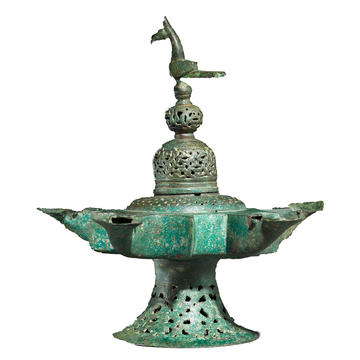 Oil lamp with dome shaped lid surmounted by a bird, EA1983.27 Oil lamp with dome shaped lid surmounted by a bird
