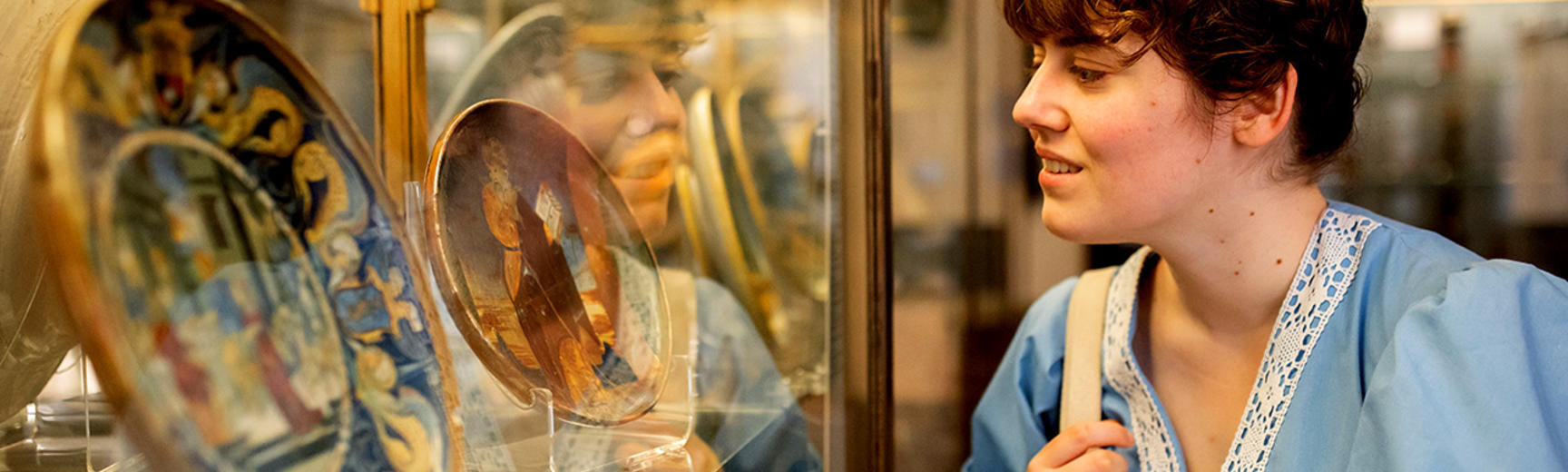 Woman looking at ceramic plates in the galleries